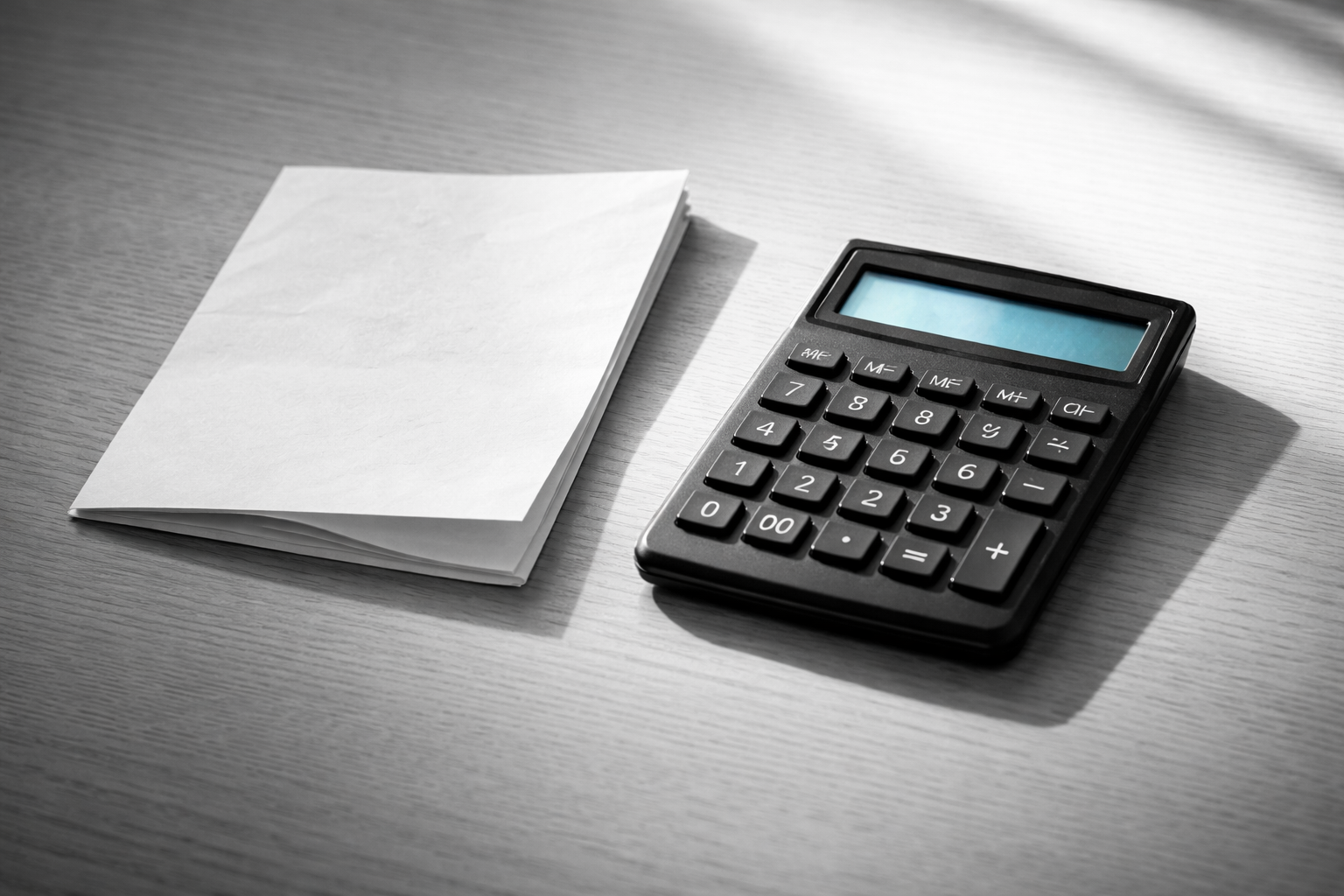 Calculator and paper in morning sunlight — running rent vs buy numbers in Indian cities