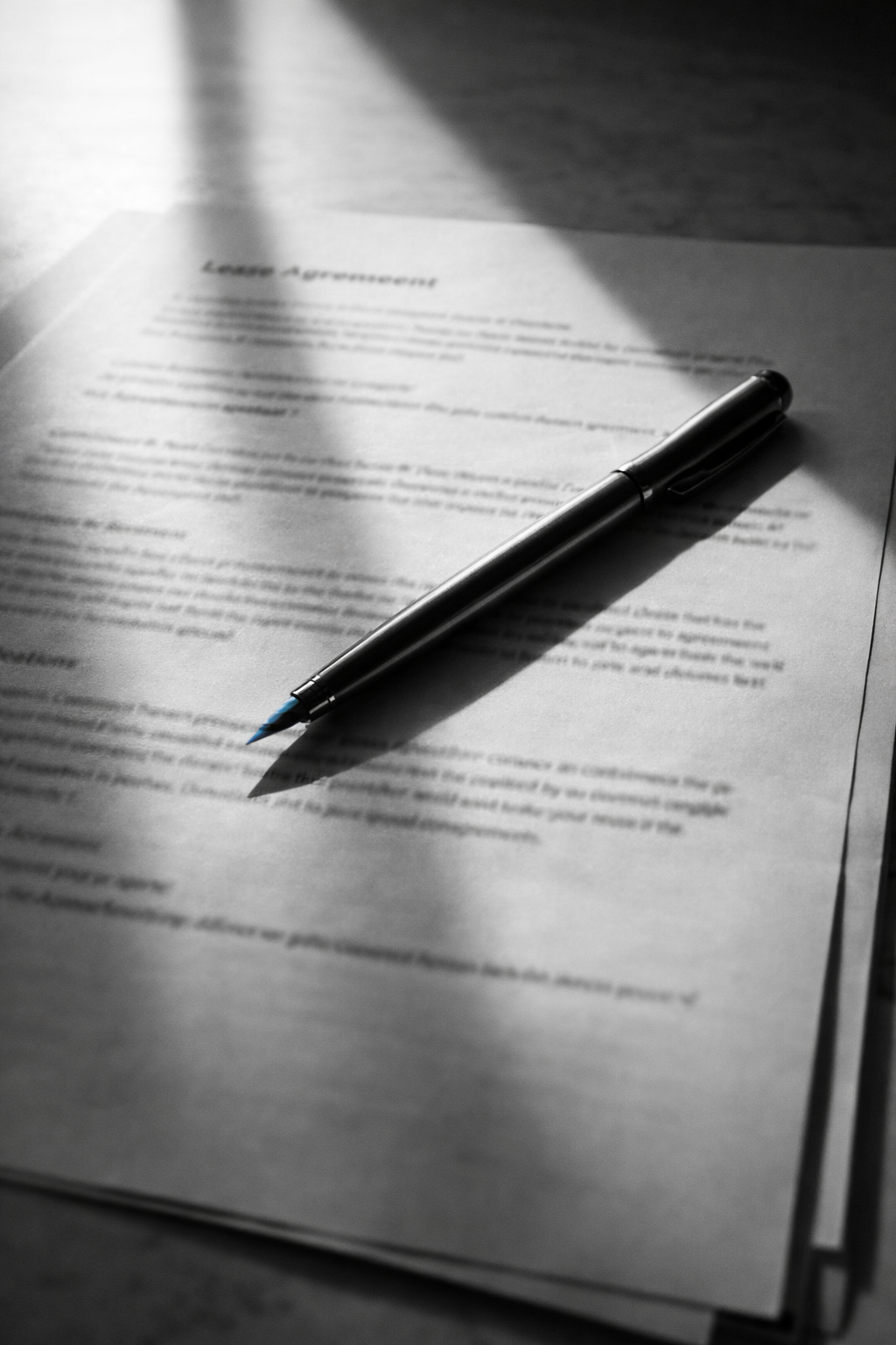 Pen resting on open lease agreement in morning sunlight — Mumbai commercial lease escalation clause 